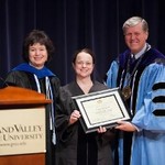 President and Provost pose with honored faculty member